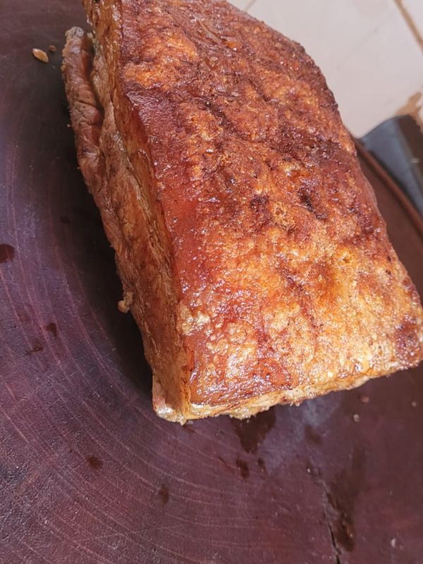 A whole piece of meat with a golden, crisp crust, just off the fire